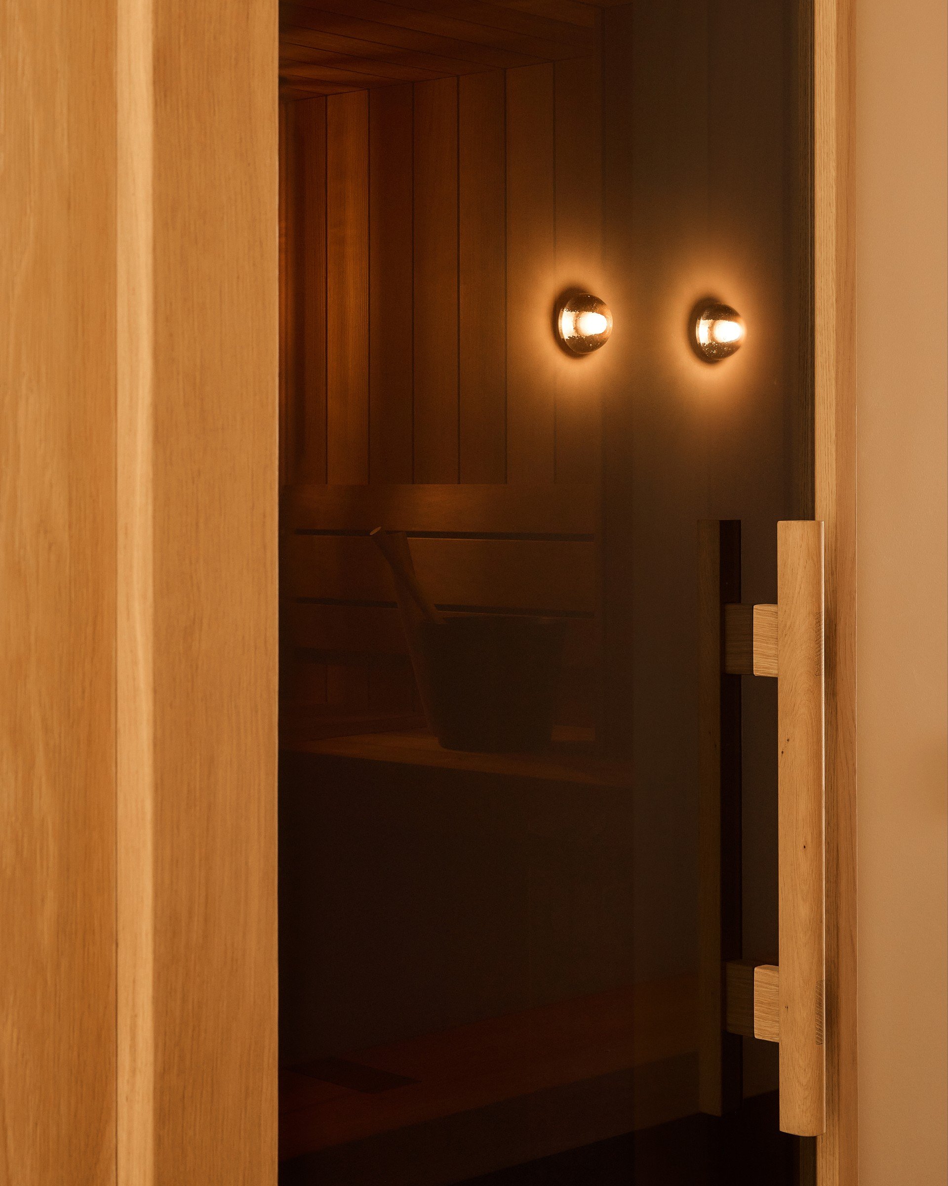 Timber spa door and sculptural wall lights
