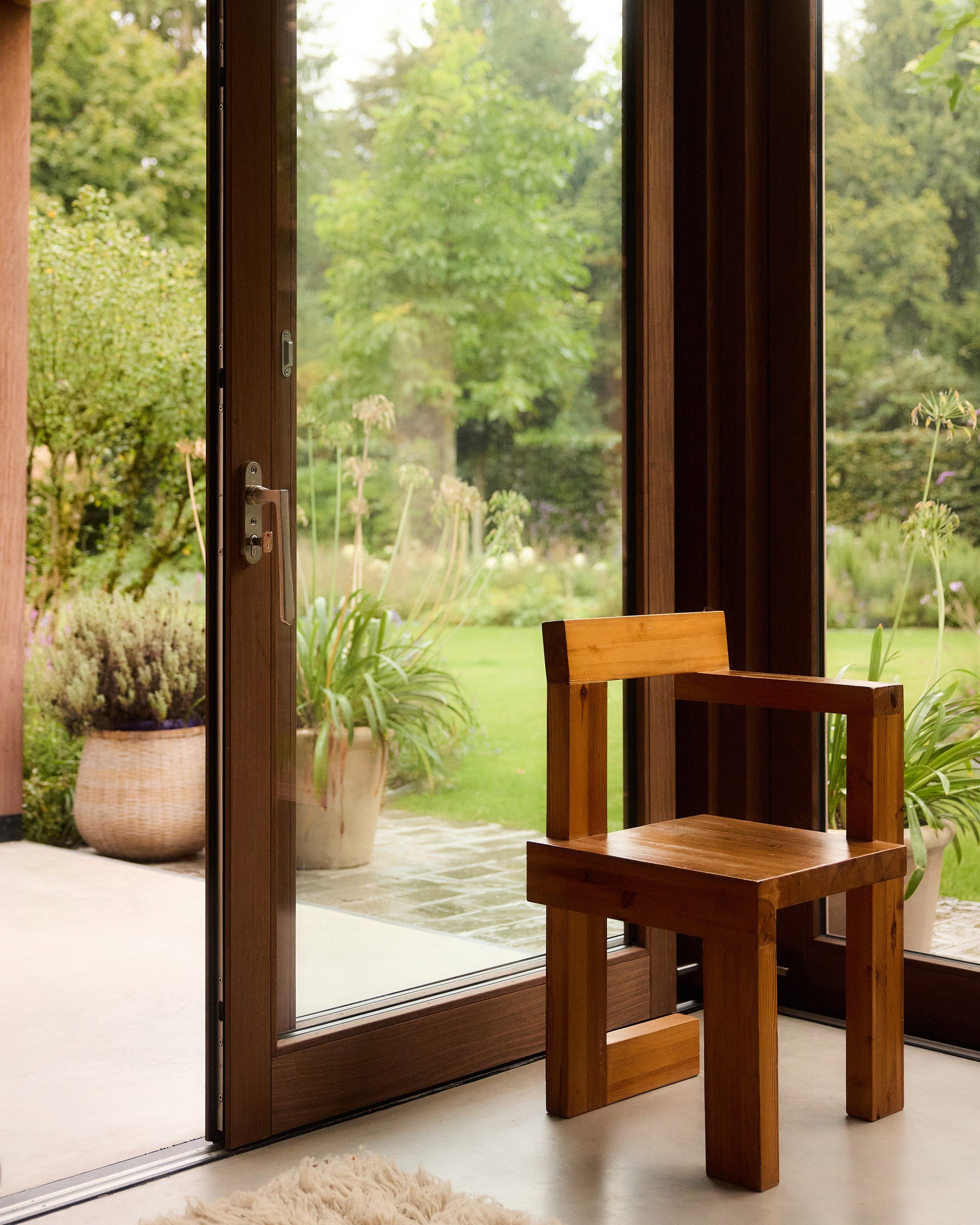 Vintage timber chair beside the garden doors